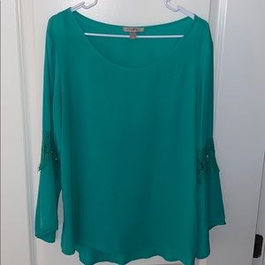 Green blouse with flared detailing on the sleeve